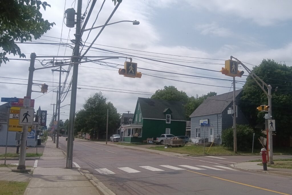 A pedestrian crosswalk on a quiet road.