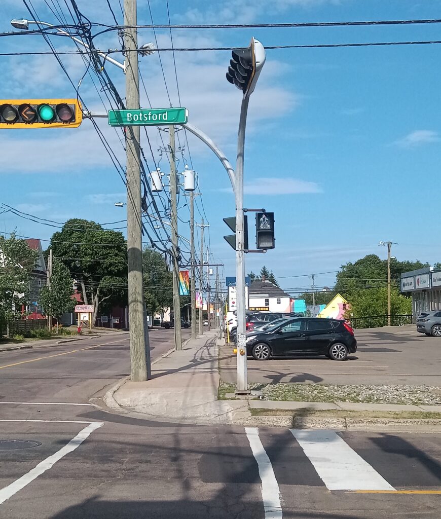 A pedestrian signal showing the walk sign.