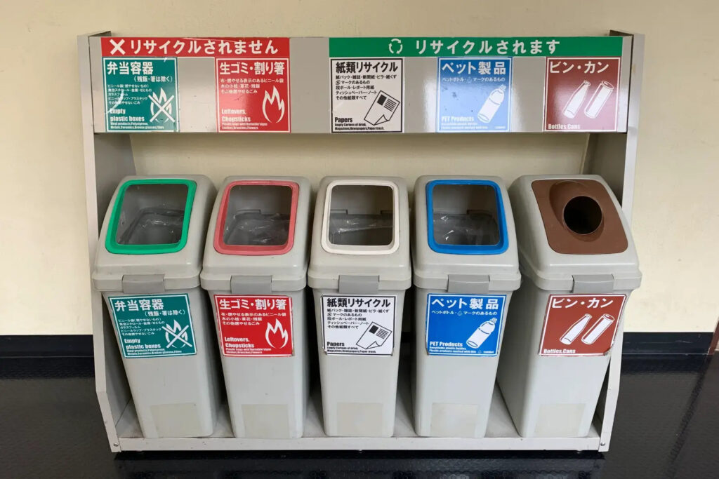 A Japanese recycling station with compartments for different types of waste.